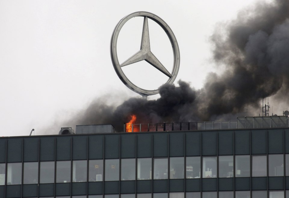 Smoke and fire is seen on the roof of the Europa-Center building in Berlin