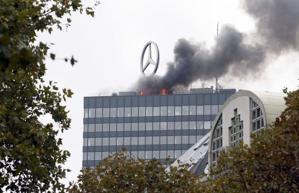 Smoke and fire is seen on the roof of the Europa-Center building in Berlin