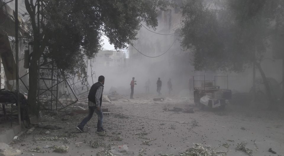 Residents inspect the debris moments after a jet dropped bombs on a neighbourhood