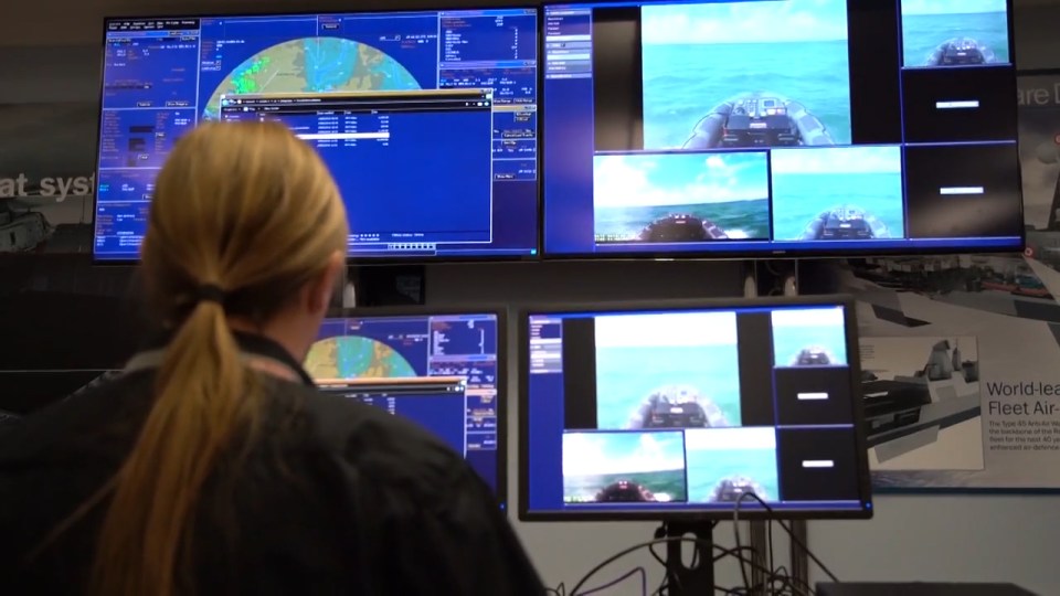 Control room . . . operator at base looks at readouts and view from boat
