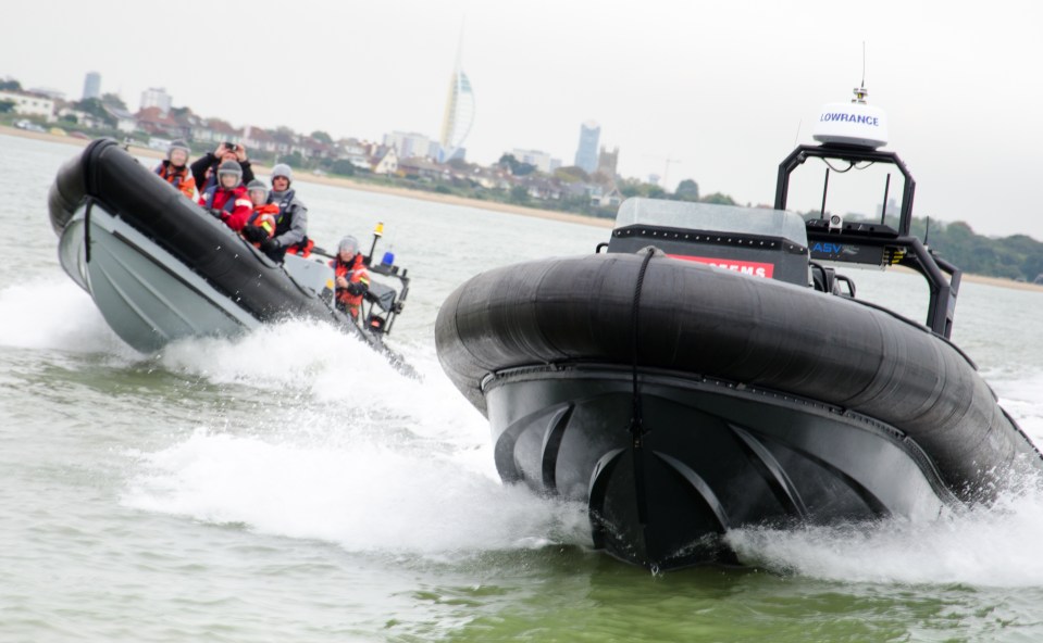 No-one at the wheel . . . unmanned vehicle being tested next to traditional equivalent