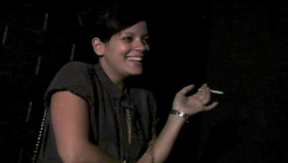 Cheeky fag . . . singer with cigarette in hand as she tells 'joke'