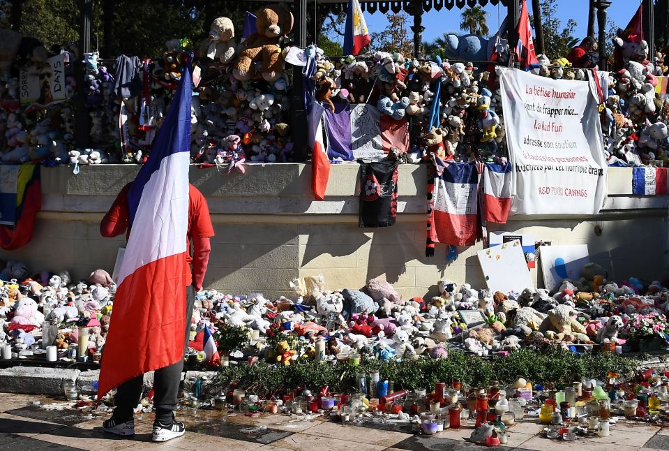 A man carrying the French national flag