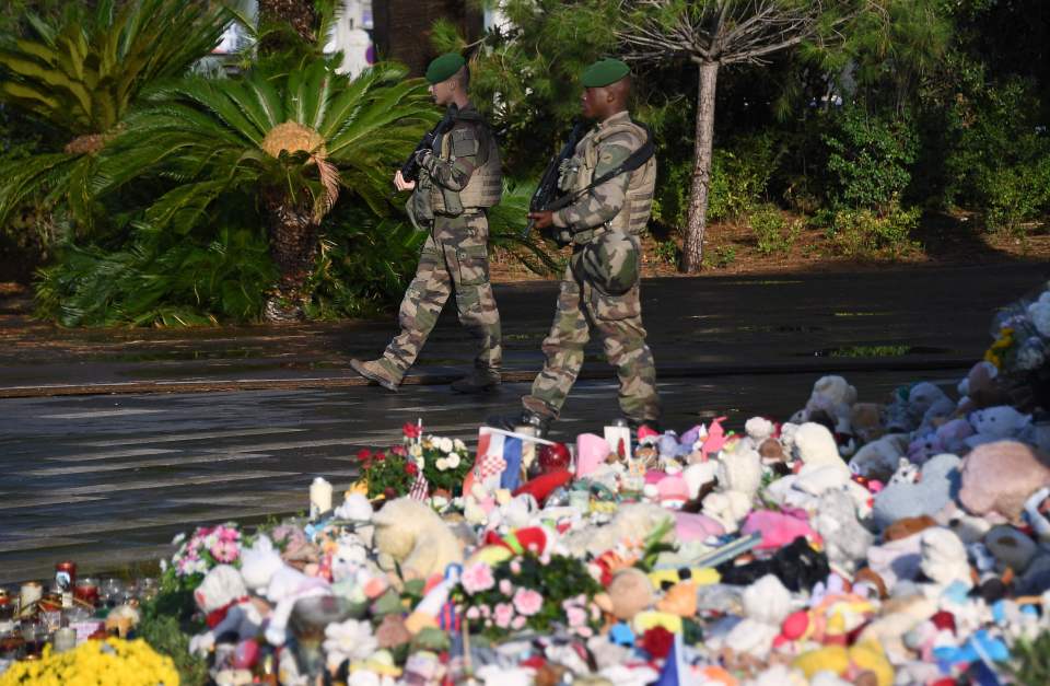 French soldiers patrol next to a makeshi