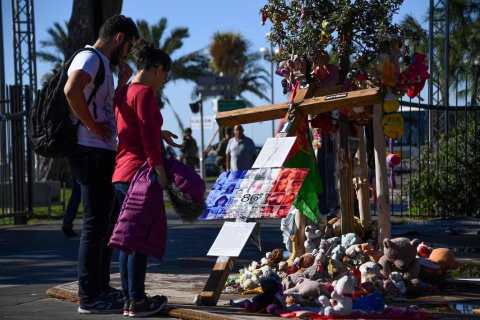 People look at pictures of victims place