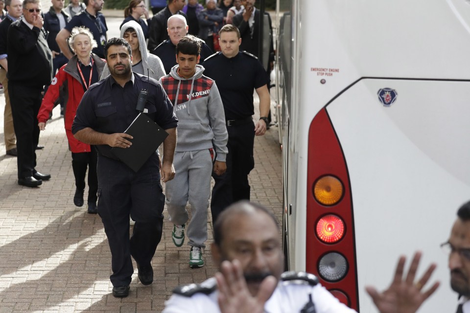 The first of the child migrants arriving in the UK this week get off a coach in Croydon