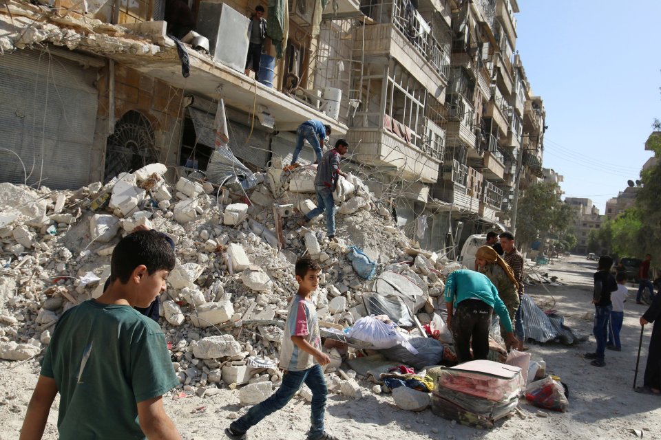 Carnage . . . children by rubble in Aleppo