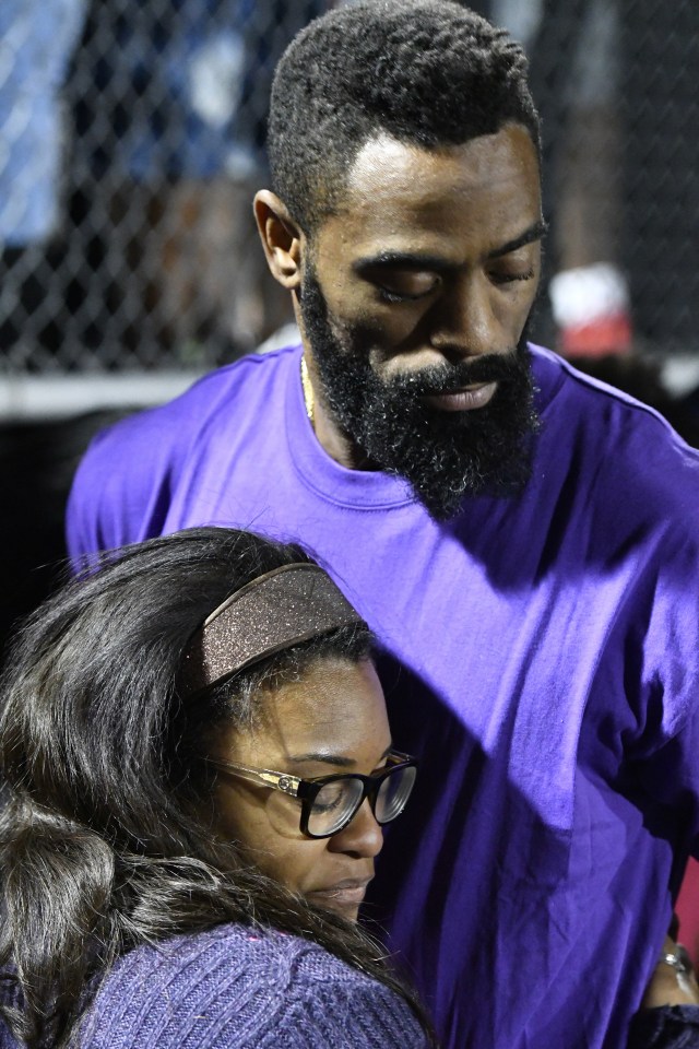 Trinity's mum embraces the Olympian father of her slain daughter at the 