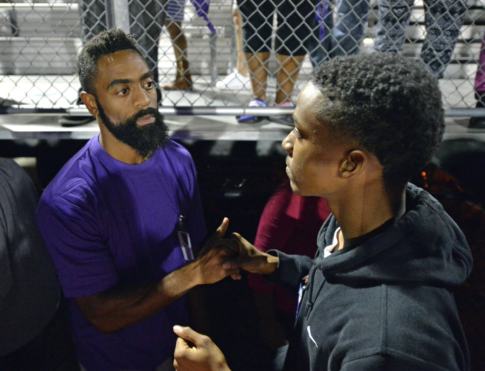 A classmate of Trinity Gay offers his sympathy to her father, Tyson Gay, following the gathering