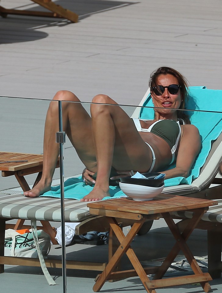 She put on her sunnies to relaxed on the sun-lounger in the soaring temperatures