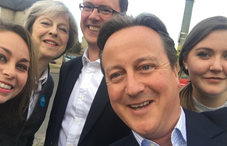 Theresa May and David Cameron were pulled into a selfie by eager supporters