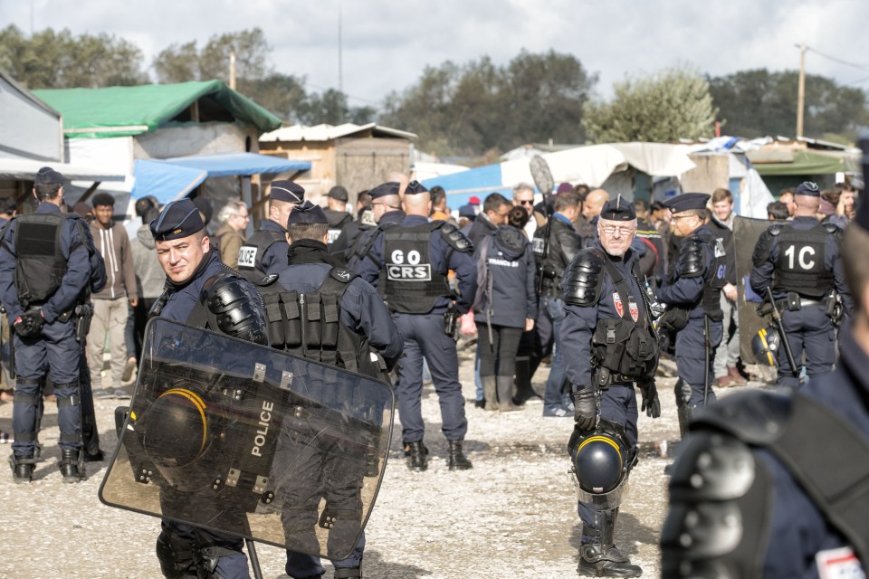 Police in the Calais "Jungle" migrant camp