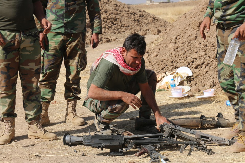 The Kurdish fighters claimed a cache of weapons after killing the extremists