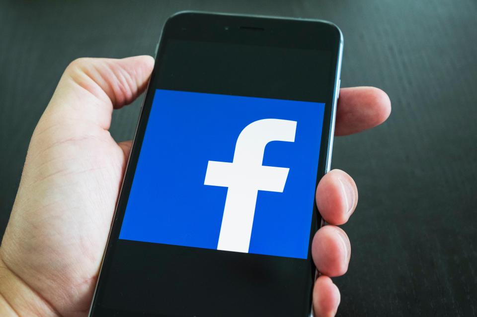 Facebook social media app logo on screen of iPhone 6 Plus smart phone