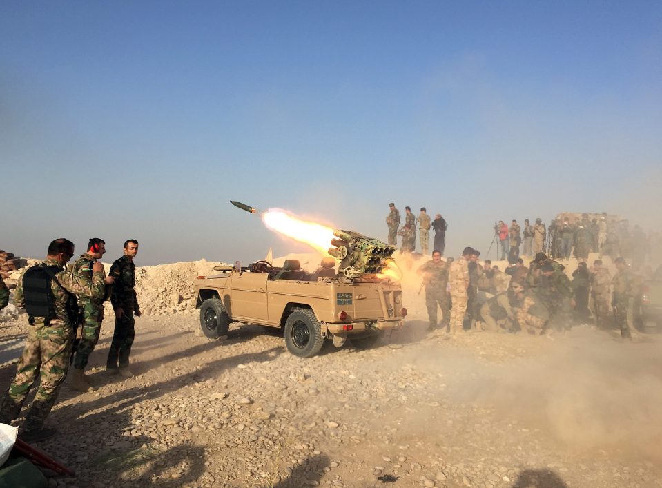 Kurdish troops fire rockets at ISIS troops in one of Mosul's outlying villages