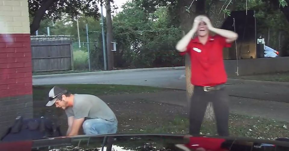 He shows the child's father how to do CPR while he explains he needs to step away to grab a CPR mask