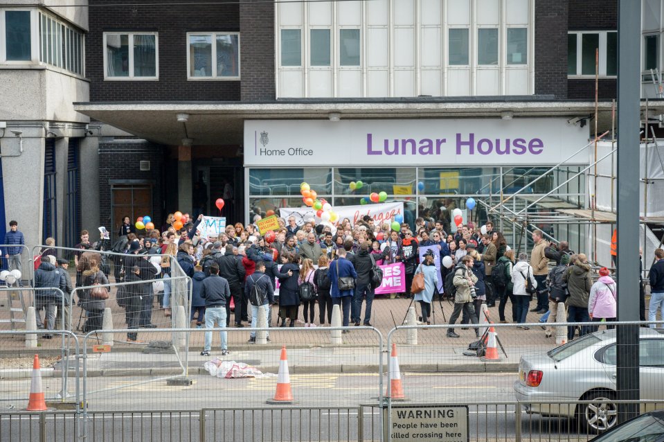 Supporters have gathered outside the Home Office to welcome the migrants