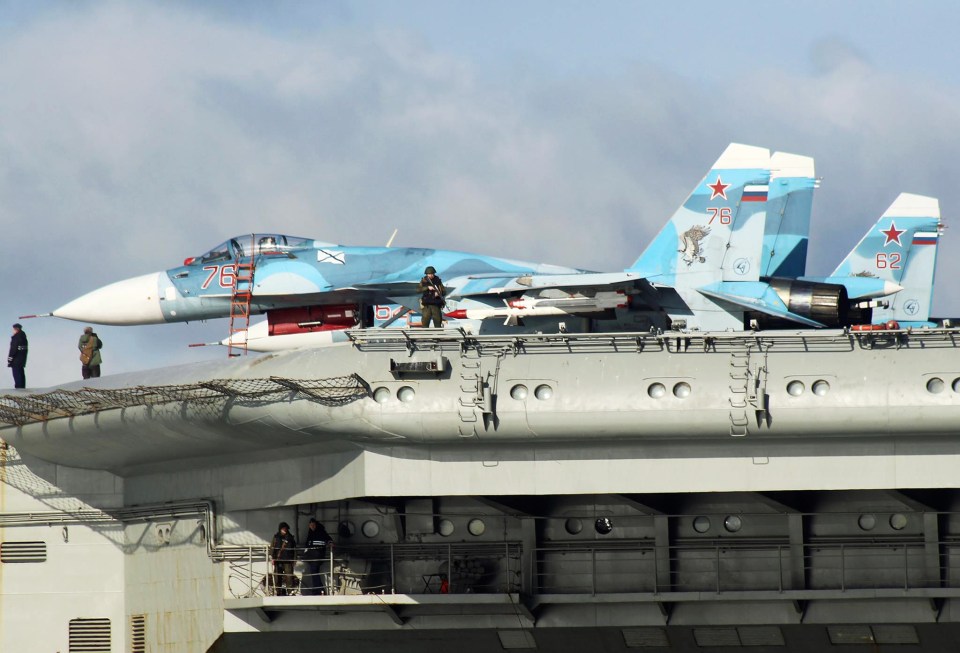 Machine gun-toting marines could be seen guarding the ship's flight deck as it passed Dover today