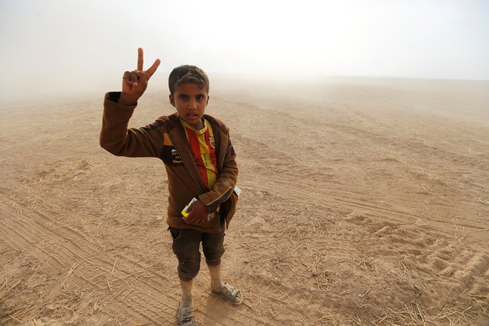 Civilians return to their village after it was liberated from Islamic State militants, south of Mosul