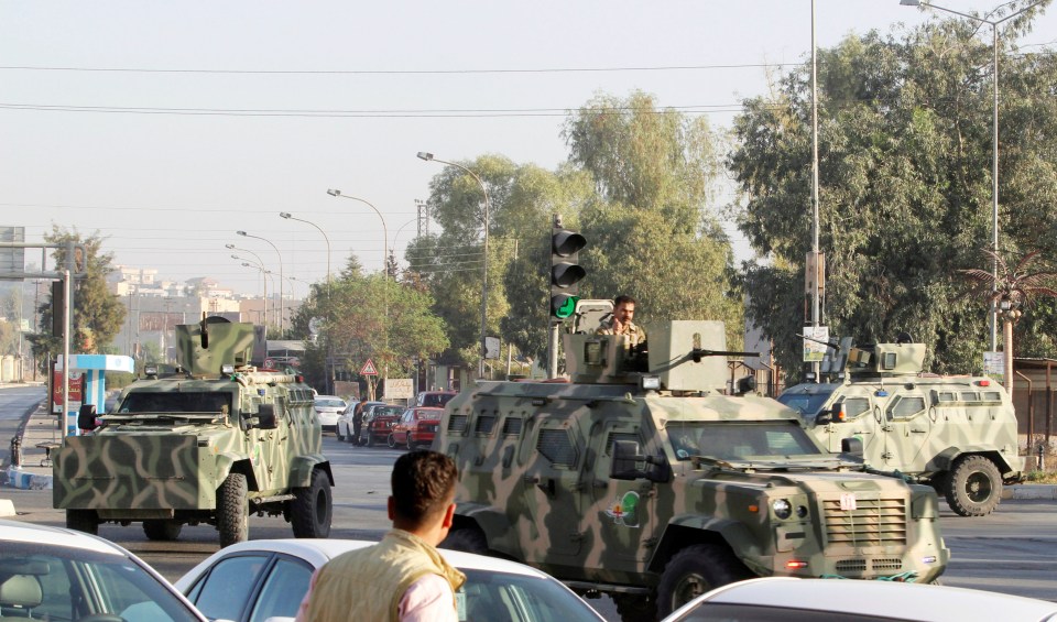 Military vehicles of peshmerga forces are seen at a site of an attack by Islamic State militants in Kirkuk