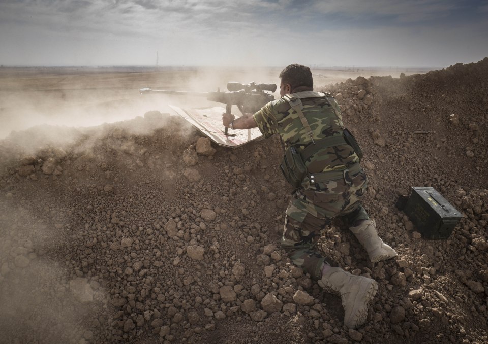 An Iraqi Army sniper takes aim during a skirmish near Mosul
