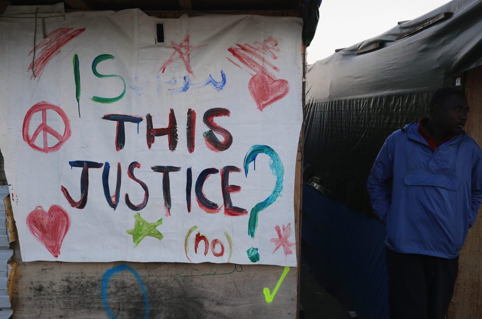 Migrants leave messages on their tents as they leave the camp