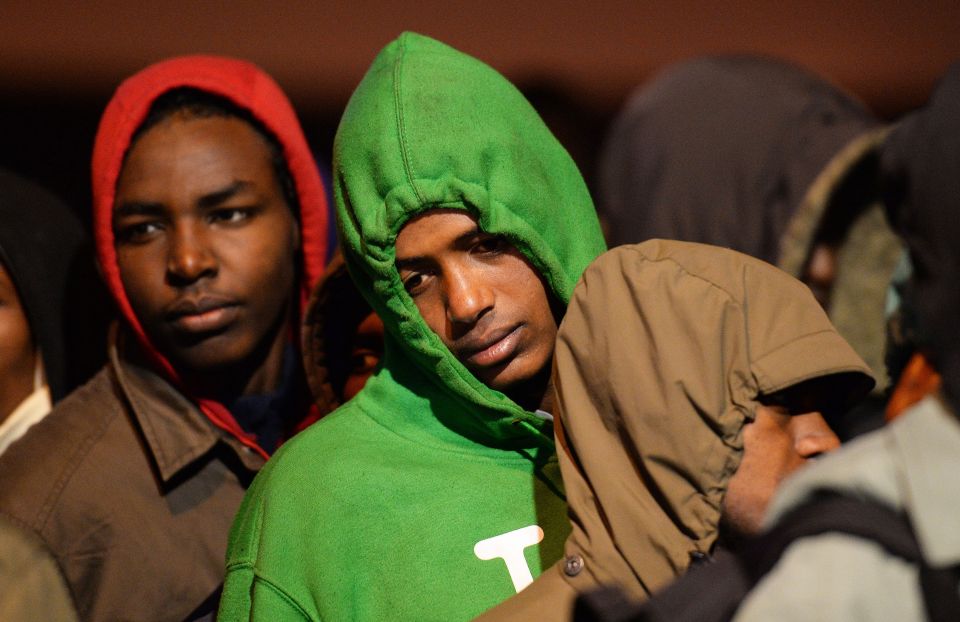 Migrants line-up to register at a processing centre in 'The Jungle' camp 