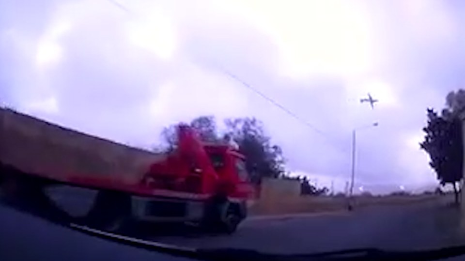 Dashcam footage first shows the plane flying low across the sky