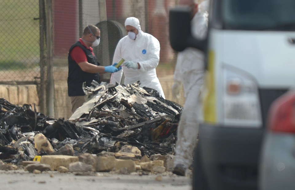 Forensic investigators work at the scene of the crash today