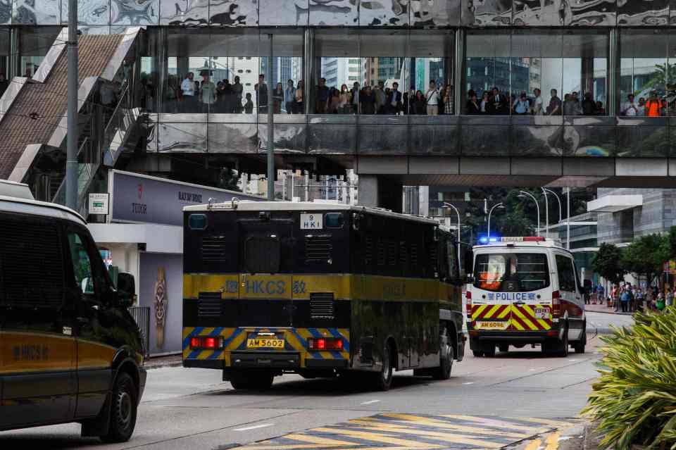 A van carrying Jutting leaves the High Court escorted by a police convoy in Hong Kong