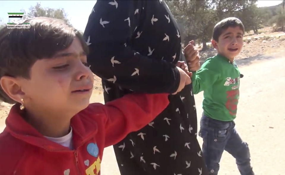 Terrified children being pulled away from the school attack in Hass.