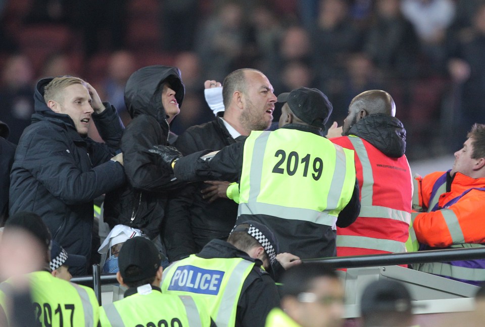 Police were forced to restrain furious fans during the crowd violence