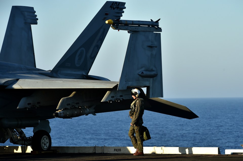 A pilot arrives at an F/A-18F Super Hornet on the US navy's super carrier USS Dwight D. Eisenhower 