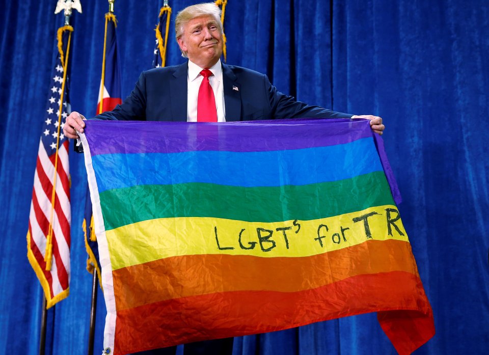 Donald Trump looked slightly sheepish as he held up an LGBT flag given to him by an audience member 