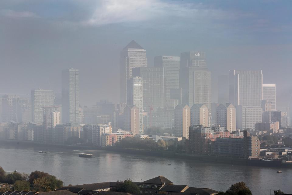 Autumnal fog over Canary Wharf in East London this morning