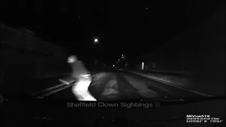The driver put his foot down and sped towards the clown, who jumped out of the way just before being hit