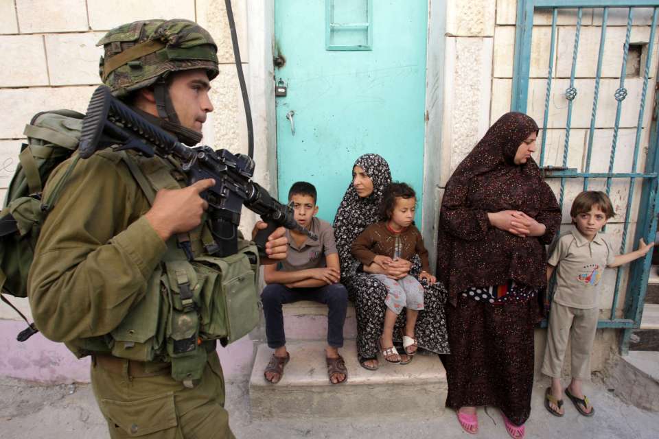 TOPSHOTSnAn Israeli soldier walks past P