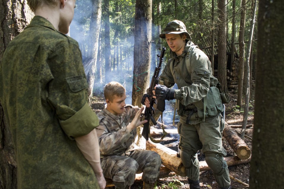 Volunteer Russians assemble a Kalashnikov before shooting practice in their makeshift camp organised by the ultra-nationalist Eurasian Youth Union