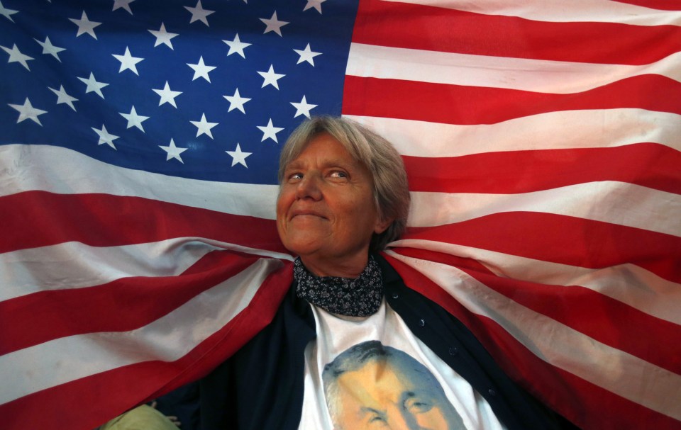 A supporter of Montenegro's Prime Minister leader Milo Djukanovic holds American flag during celebration after October's parliamentary elections 