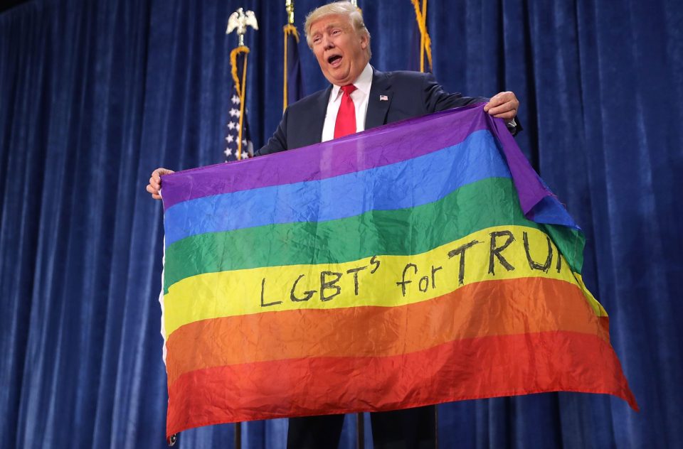 Donald Trump held a rainbow flag given to him by a supporter during a campaign rally before he won the election