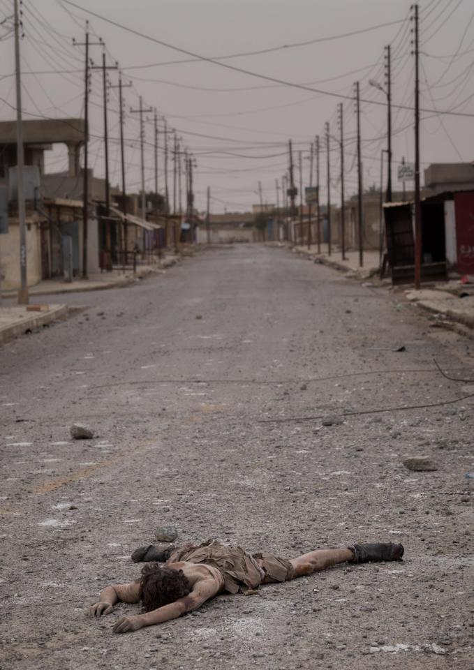 A dead body of a young ISIS fighter boy lies in the vacant street of Shora. Iraqi army troops took control of the village several days ago in the south of Mosul as part of their operations to retake the city 