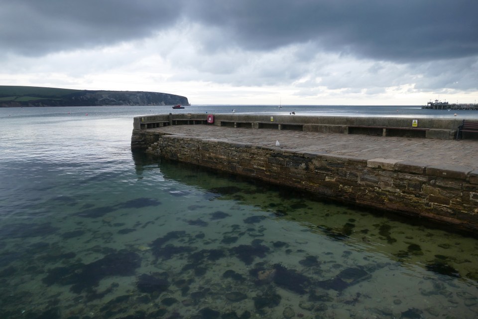 Wintery weather looms over the sea at Swanage Bay in southern England