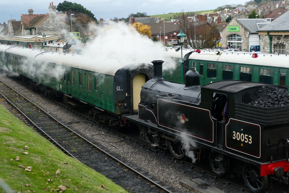 Steam trains give out a puff of steam on a chilly morning in Dorset