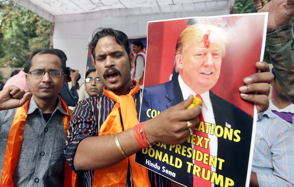 They burn pictures of Democrat candidate Hillary Clinton