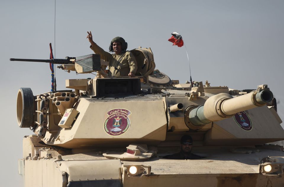 An Iraqi army M1 Abrams tank drives through Gogjali as it heads into Mosul