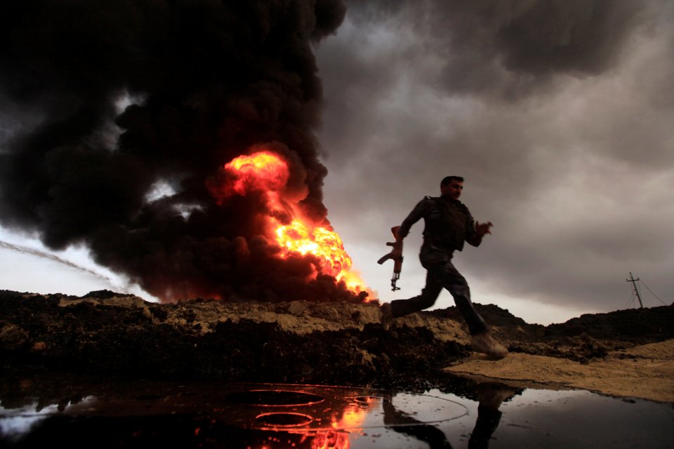 Flames and smoke rise from oil wells set ablaze by ISIS militants 
