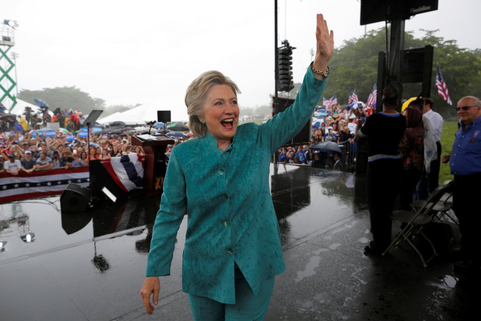 Hillary Clinton waves to supporters in the Florida rain today