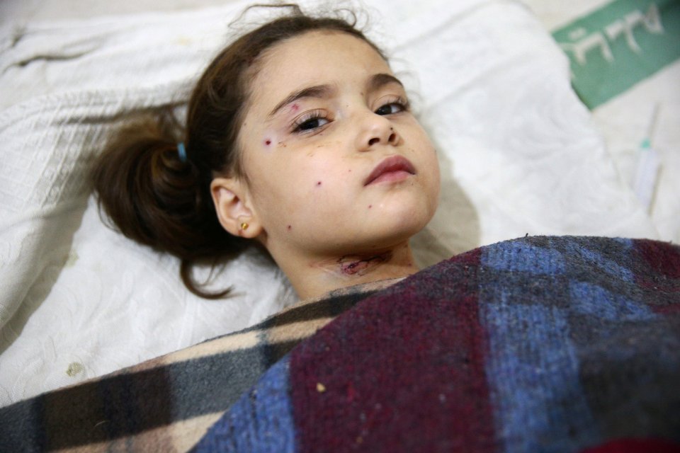 An injured girl rests in a field hospital after the nursery bombing