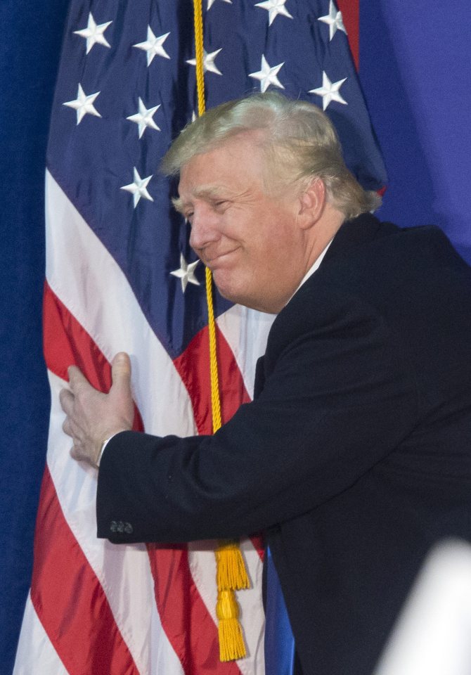 Snuggle, stars and stripes...Trump hugs the American flag