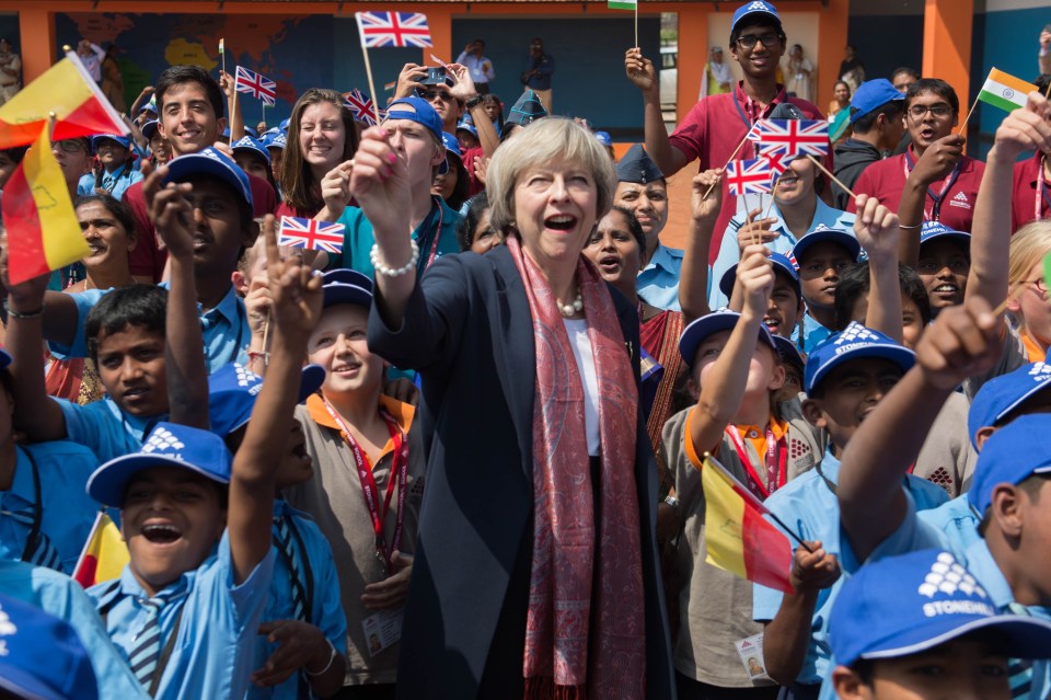 Mrs May with pupils at Stonehill Government Primary School in Bangalore